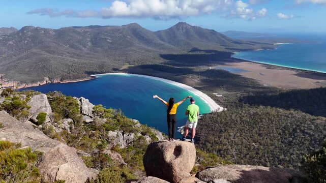 Aerial drone view of Tasmania Island. Wineglass Bay hike, Freycinet National Park. People enjoying the beautiful view after a strenuous hike. Tasmania, Australia.