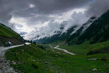 Obraz premium Stormy weather, cloudy sky and dramatic scenic beauty of Himalayan mountains , green mountain valley, way to Kargil from Srinagar, Jammu and Kashmir, India.