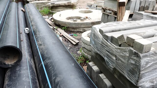 Stormwater drainage and sewer pipes stored at construction site for infrastructure and utility installation works