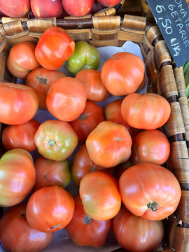 Sun-ripened tomatoes overflowing a rustic oak basket