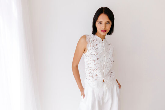 Woman wearing elegant white lace top