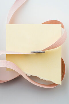 Silver Ring with Pink Silk Ribbon and Torn Paper Note Mockup