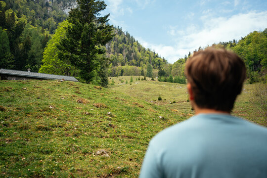 Young Hiker Looking Out Over Alpine Meadow