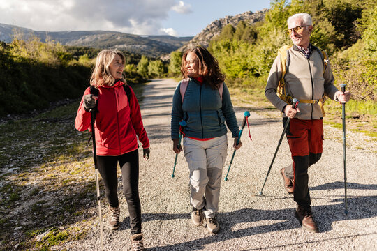 Active senior friends enjoying an outdoor trekking adventure