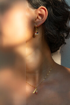 Woman in Handcrafted Beaded Necklace and Matching Drop Earrings