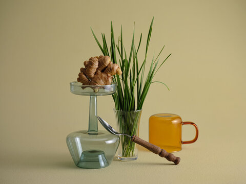 Ginger root, chives, and tea in a still life composition