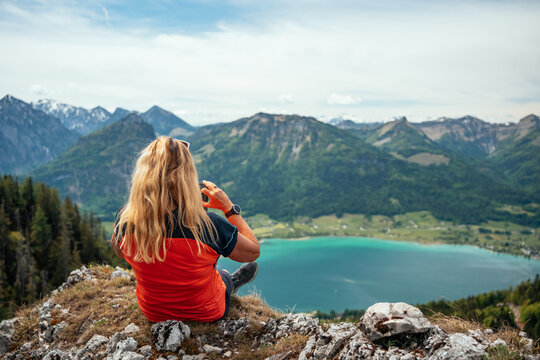 Woman taking a photo of the beautiful landscape
