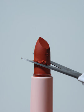 Cutting a lipstick with scissors