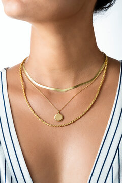 Woman Wearing Layered Gold Necklaces