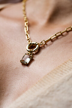 Woman Wearing Gold Link Chain Necklace with Crystal Pendant