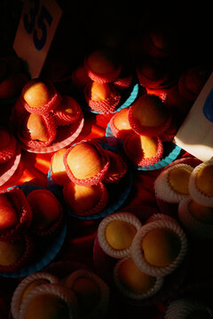 Colourful apples displayed at a market stall in the evening light