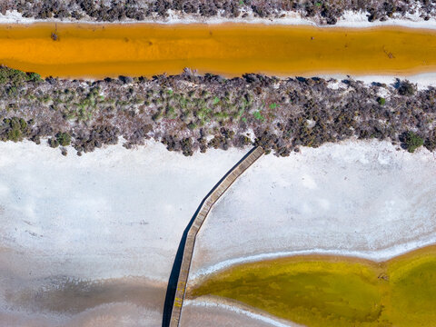 Wooden bridge over a drying salt lake