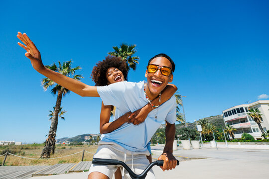 Happy partners enjoying summer scooter ride