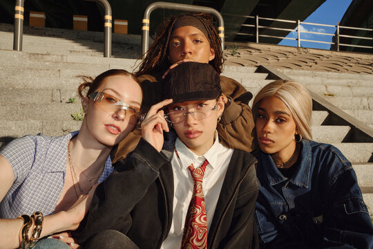 group Portrait of stylish friends posing on riverside steps in Seoul