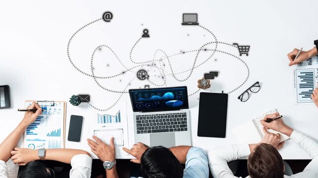 A diverse team collaborates in a modern workspace, utilizing digital devices to analyze data trends and develop effective strategies for business growth, showcasing teamwork. Raster