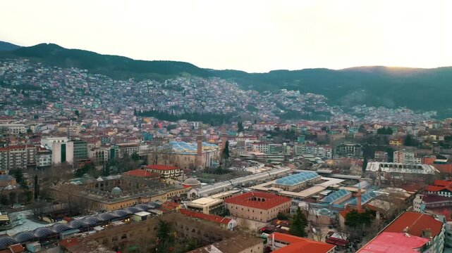 Bursa Ulu Cami drone aerial shot showing its historic domes and minarets in Turkey. Scenic bird's eye view of the famous Ottoman architecture.