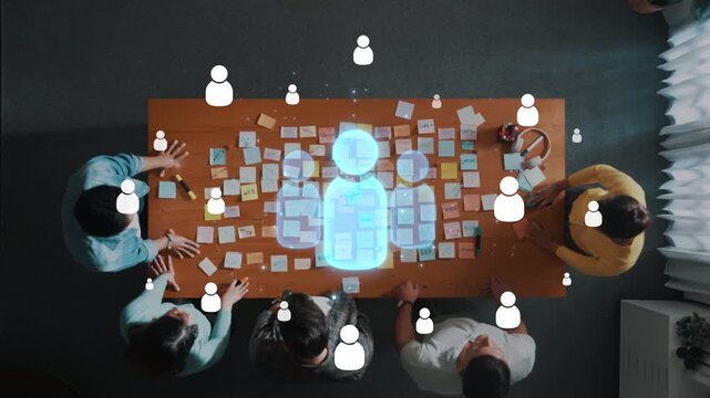 An aerial view showcases a diverse team engaged in a brainstorming session using sticky notes on a wooden table, emphasizing creativity and collaboration. Raster
