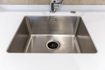 Fototapeta premium Stainless kitchen sink with food waste disposal in modern home