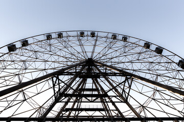 Fototapeta premium silhouette of Ferris wheel on the background of blue sky