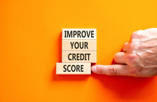 Improve your credit score words symbol. Concept words Improve your credit score on beautiful wooden blocks. Beautiful orange background. Business improve your credit score concept. Copy space.