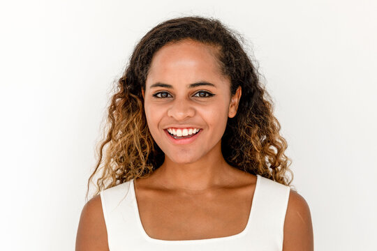 Smiling woman in white top.