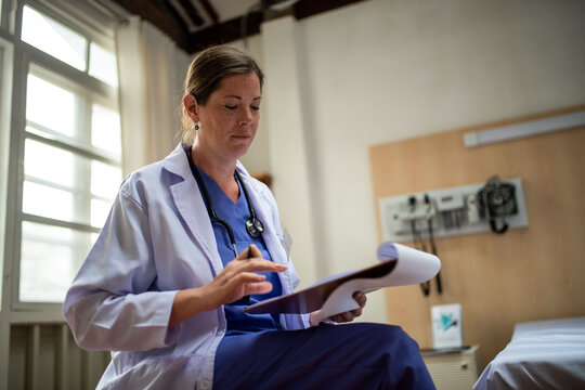 Focused doctor reviewing patient files