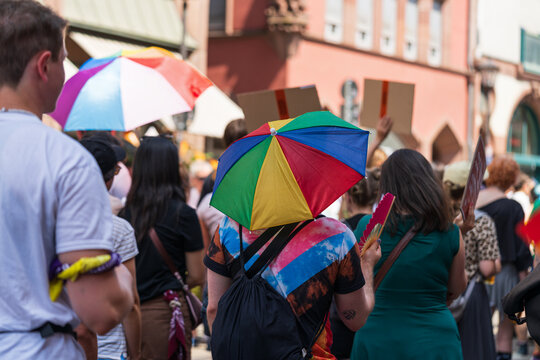 Participant carrying rainbow umbrella during CSD Pride march