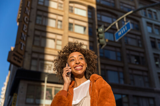 Woman smiling urban phone call