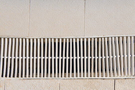 Swimming Pool Overflow Drainage Grate Close Up on Pool Deck Water Management System