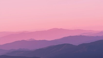 Obraz premium Layers of mountains under a pink sky at sunset