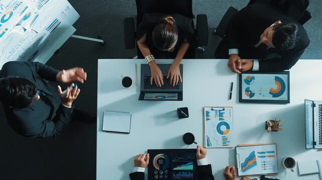 Top down aerial view of smart boss invites project manager to explain about marketing plan at white board. Group of diverse investor listen presentation while working and analyze chart. Directorate.