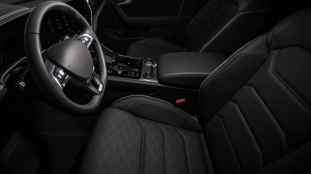 Dark interior features sleek, black leather seats