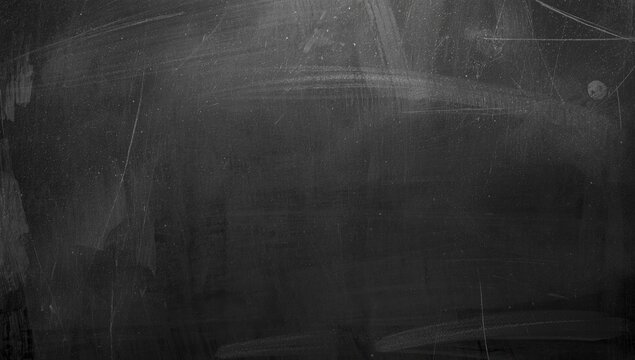 Black chalkboard surface with scratch marks and smudges