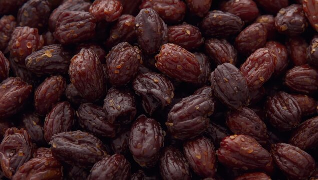 Dried dark red raisins stacked in a pile