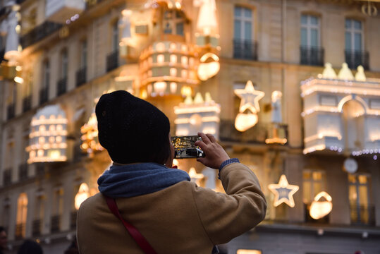 Taking Pictures of Christmas Decorations at Traditional Haussmann Building in Paris, France