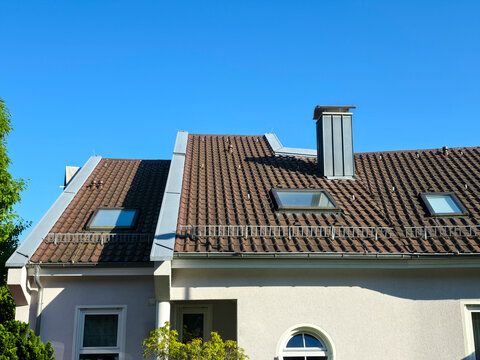 charming traditional house roof in excellent condition under brilliant blue sky showcasing timeless residential appeal