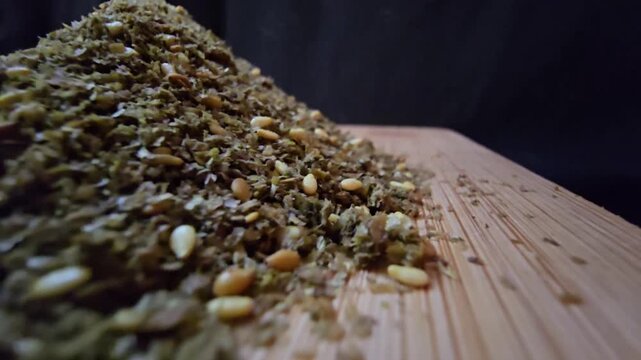 Close-up shot of a bowl filled with high-quality traditional za'atar spice mix, featuring toasted sesame seeds and aromatic dried herbs, gourmet middle eastern culinary ingredient, textured food backg