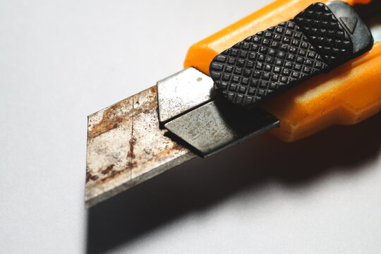 A close-up view of a knife lying on a table, ready for use