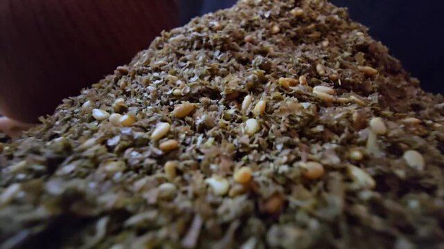 Close-up shot of a bowl filled with high-quality traditional za'atar spice mix, featuring toasted sesame seeds and aromatic dried herbs, gourmet middle eastern culinary ingredient, textured food backg