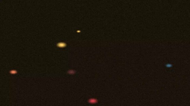 Floating Colored Dots in Dark Jumping Scene
