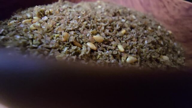Close-up shot of a bowl filled with high-quality traditional za'atar spice mix, featuring toasted sesame seeds and aromatic dried herbs, gourmet middle eastern culinary ingredient, textured food backg