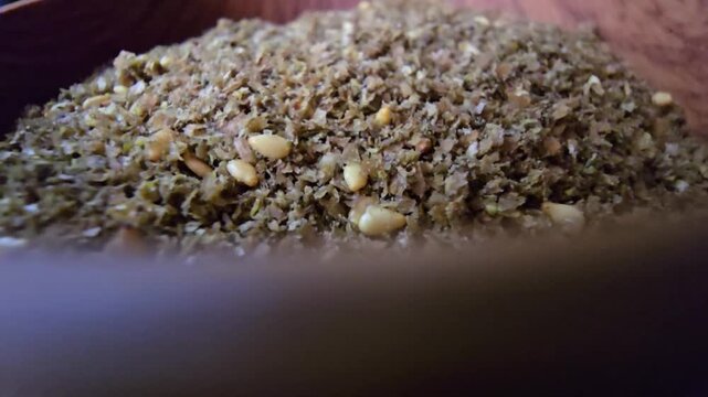 Close-up shot of a bowl filled with high-quality traditional za'atar spice mix, featuring toasted sesame seeds and aromatic dried herbs, gourmet middle eastern culinary ingredient, textured food backg