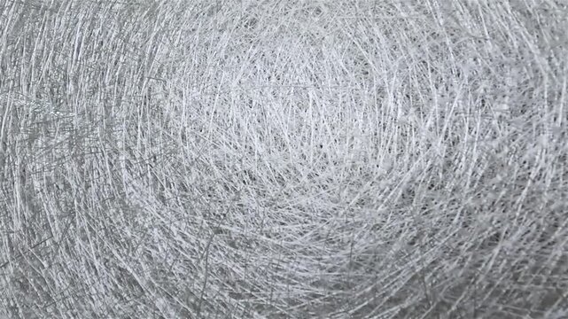 Fiberglass Mat Rolls for Composite Manufacturing. Fiberglass Reinforcement Material in Production Workshop. Material for the manufacture of fiberglass products. A skein of fiberglass material.