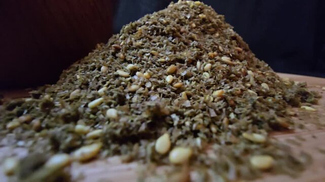Close-up shot of a bowl filled with high-quality traditional za'atar spice mix, featuring toasted sesame seeds and aromatic dried herbs, gourmet middle eastern culinary ingredient, textured food backg