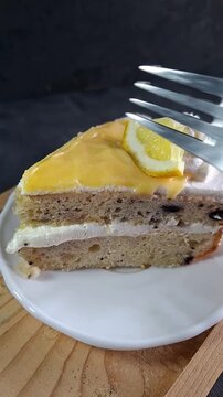 Eating Lemon Raspberry Cake. Taking a Bite of Cake with Fork