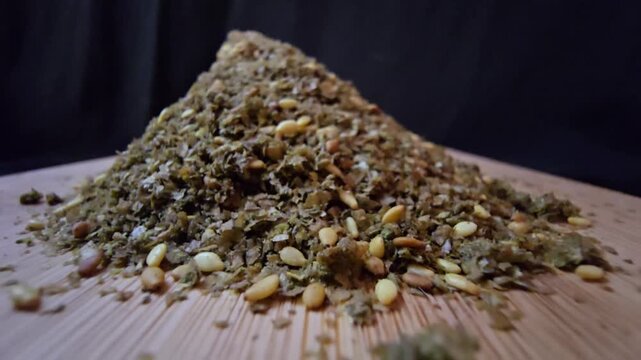 Close-up shot of a bowl filled with high-quality traditional za'atar spice mix, featuring toasted sesame seeds and aromatic dried herbs, gourmet middle eastern culinary ingredient, textured food backg