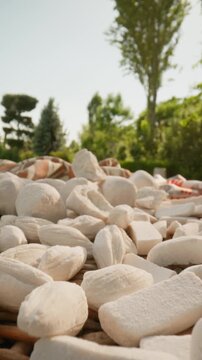 Close-up of traditional Uzbek kurt, dried fermented cheese balls displayed outdoors. Popular Central Asian dairy snack made from natural milk. Authentic local food, nomadic culinary heritage and