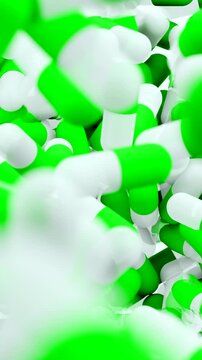 Green and white capsules falling and filling the screen. 3D animation of medical pills. Pharmacy and healthcare concept. Vertical video.