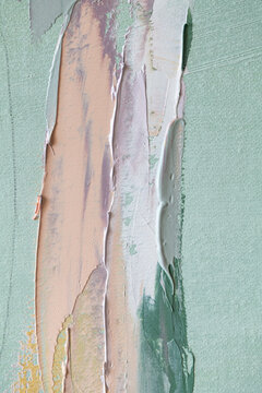 Mixing paint with a palette knife on an oil painting surface in a studio setting