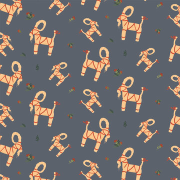 Scandinavian Yule Goat Seamless Pattern on Grey Blue Background. Nordic Christmas Straw Figurine Backdrop with Red Ribbons, Winter Berries, and Evergreen Branches for Festive Fabric and Wrapping Paper